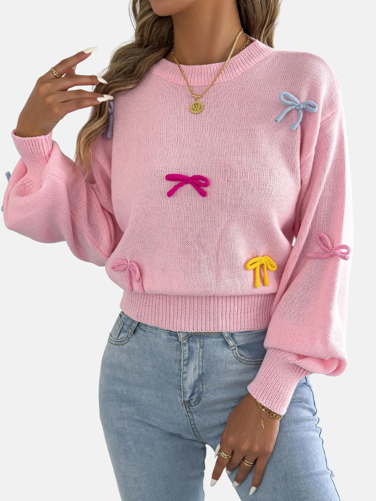 Pull rose à nœuds colorés